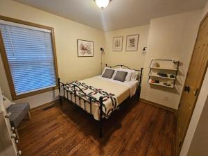 a bedroom with a bed and a window at The American Carriage House in Liberty