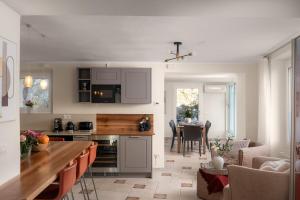 a kitchen with a table and a dining room at Villa Melody by Aura Luxury Collection in Molino Nuovo