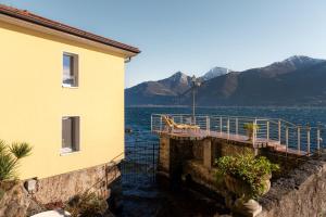 a building with a dock next to a body of water at Villa Melody by Aura Luxury Collection in Molino Nuovo