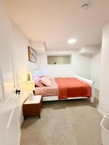 a bedroom with a bed and a window at Cozy 2 Bedroom Suite Close to Amenities in Edmonton +27 photos