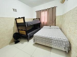 En eller flere senge i et værelse på Casa em Bertioga com piscina aquecida Sitio família ROCHA + 16 billeder