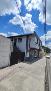 a white building on the side of a street at Apartamento Bela Vista in Canoinhas