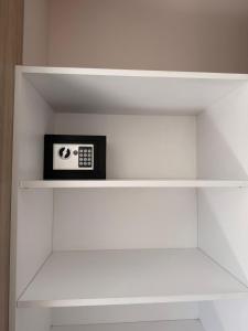 a clock sitting on a shelf in a closet at Hotel Playas De Oro in Villa Carlos Paz