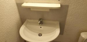 a white toilet in a bathroom with a sink at Studio meublé centre ville Paray A4 in Paray-le-Monial +2 photos