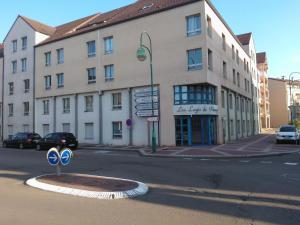 a large white building with a street sign in front of it at Studio meublé centre ville Paray A4 in Paray-le-Monial