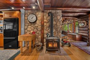 a stone wall with a stove in a kitchen at Lookout Log Cabin in Rhododendron +70 photos