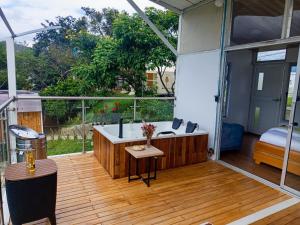 Una habitación grande con bañera en una terraza. en Cabaña Colibrí Silvania Cundinamarca, en Silvania 2 fotos más