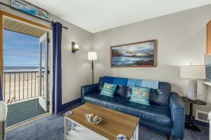 a living room with a couch and a view of the ocean at Oceanfront Suite - Sleeps Six - Pool & Hot Tub in Lincoln City +29 photos