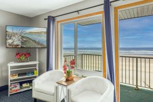 a living room with two chairs and a view of the ocean at Oceanfront Suite - Sleeps Six - Pool & Hot Tub in Lincoln City