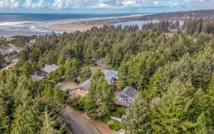 an aerial view of a house on a hill next to the ocean at Waldport Serenity in Waldport