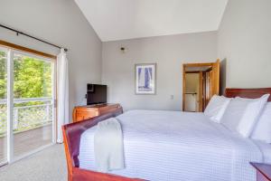 a bedroom with a large bed and a window at Waldport Serenity in Waldport