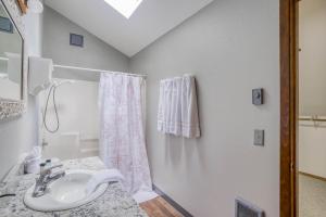 a white bathroom with a sink and a shower at Waldport Serenity in Waldport