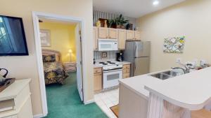 Royal Poste Unit 2605 في صن سيت بيتش: مطبخ صغير مع حوض وثلاجة