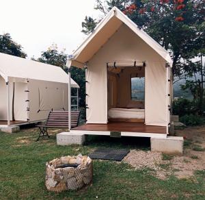 a small white tent with a bed in it at Cabaña tipi Ardilla Silvania Cundinamarca in Silvania