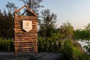 a wooden sign in front of a garden at Camp Cayla - COASTA in Ban Ao Makham Pom +8 photos