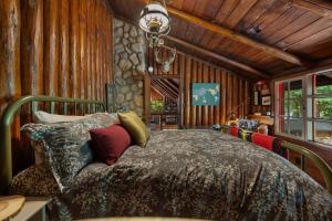 a bedroom with a bed in a room with wooden walls at Lookout Log Cabin in Rhododendron