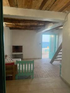 TamriAJARIF ⴰⵊⴰⵔⵉⴼ - Fisherman cabin的卧室里有一张绿色长椅，可以欣赏海景