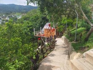 a train traveling down a hill next to a sidewalk at Glamping Morpho Azul Silvania Cundinamarca in Silvania