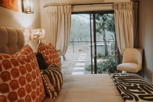 a bedroom with a bed with pillows and a window at Wildlife Estate Villa - Pool - Boma - Bushlife in Hoedspruit +39 photos