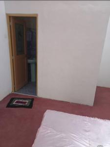 a room with a bed and a hallway with a door at Uva Guest Udawewa in Diyatalawa