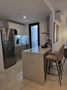 a kitchen with a counter and a refrigerator at Feel Premiun 1204 in Asuncion
