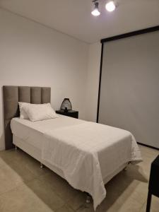a bedroom with a large white bed in a room at Feel Premiun 1204 in Asuncion