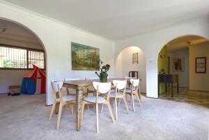 a dining room with a table and chairs at Relaxing at acreage farmhouse in Burrawang