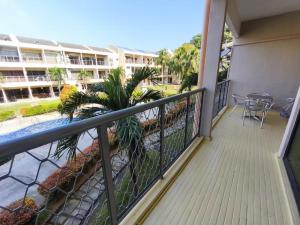 a balcony of a condo with a view of a pool at Ayu Blue Lagoon PD by GPH in Gua Sai