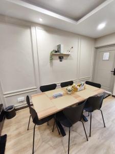 a meeting room with a wooden table and chairs at Ayu Blue Lagoon PD by GPH in Gua Sai