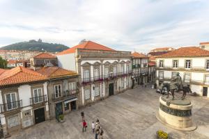 a city with a statue of a horse in a courtyard at Bright Sao Domingos Apartments in Viana do Castelo
