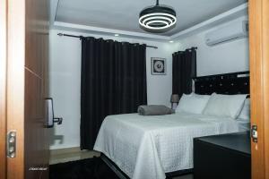 a bedroom with a large bed with black curtains at Penthouse Palmares SkyView in La Romana +11 photos