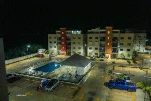 a parking lot with a pool in front of a building at Penthouse Palmares SkyView in La Romana