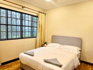 a bedroom with a large bed and a large window at Deco Home The Oasis Mesilau at Kundasang in Kundasang