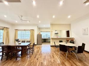 an open kitchen and dining room with tables and chairs at Deco Home The Oasis Mesilau at Kundasang in Kundasang