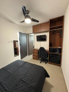a bedroom with a bed and a ceiling fan at Cuarto independiente frente al museo del desierto in Saltillo