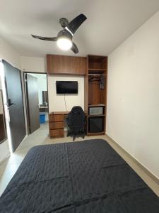 a bedroom with a bed and a ceiling fan at Cuarto independiente frente al museo del desierto in Saltillo