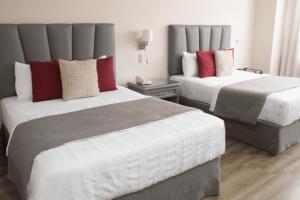 Postel nebo postele na pokoji v ubytování Hotel Santander Plaza