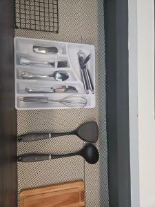 a drawer filled with utensils in a cabinet at Jazmin's Apartment in Oranjestad