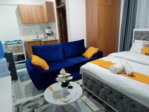 Naivera Membley star heights في Ruiru: غرفة معيشة مع أريكة زرقاء وطاولة