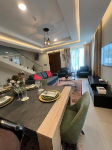 a kitchen and living room with a table and chairs at Maison Aria in Madina +25 photos