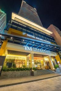 a building with a hotel southern waikiki sign on it at Hotel Soleil Ha Long, Trademark Collection by Wyndham in Ha Long
