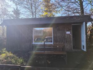 a small building with a window and a bench at Filipka - Camp pod kaštany in Morávka +4 photos