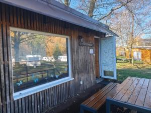 a building with a window and a bench next to it at Filipka - Camp pod kaštany in Morávka