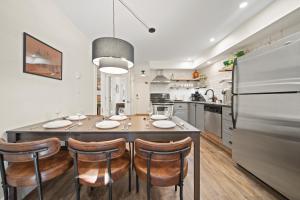 a kitchen with a table with chairs and a refrigerator at Whistler Lakeside Hideaway in Whistler