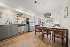 a kitchen with a large dining table and chairs at Whistler Lakeside Hideaway in Whistler