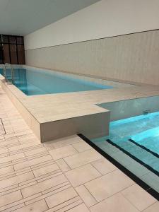 a swimming pool with a bench in the middle of it at 2bedroom city central appletv Homepod pool sauna in Melbourne