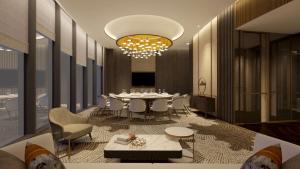 een eetkamer met een tafel, stoelen en een kroonluchter bij Hilton Shaoxing Hotel And Residences in Shaoxing