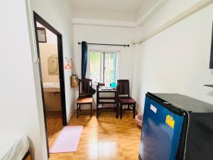 a room with a table and a dining room at Miss Hong House in Ko Samed