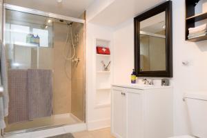 a bathroom with a shower and a sink and a mirror at King Suite Between City and Slopes in Denver +19 photos