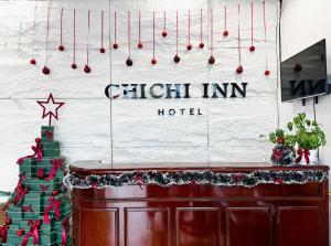 a room with a christmas tree and christmas ornaments at Chichi Inn Hotel CoTo in Đảo Cô Tô +28 photos